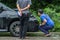KAMPHAENG PHET, THAILAND - JULY 17 : An unidentified people checking front of black car which got damaged by accident on the road