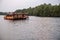 Kampot, Cambodia - 12 Apr 2018: tourist ferry on still river outdoor landscape. Fireflies tour by traditional wood boat