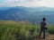 KANCHANABURI, TH - JANUARY 16; One man stood looking at the panoramic view on the top of the Chang Phuak mountain