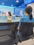 KANCHANABURI, THAILAND - AUGUST 27, 2020 : Unidentified female customer wear face mask waiting to transact with bank staff during
