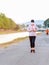 KANCHANABURI/THAILAND-MAY 7,2020 : Unidentified Thai sportive woman must wears protective mask on face jogging for good health due