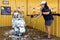 KANCHANABURI, THAILAND-NOVEMBER 21,2023 : Unidentified happy woman washing self-service her motorcycle at automatic coin-operated