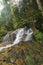 Kanching Waterfall located in Malaysia, amazing cascading tropical waterfall. wet and mossy rock, surrounded by green rain forest