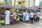 KANDY, SRI LANKA - JULY 19, 2016: White clothed buddhist devotees buy lotus flowers during Poya Full Moon holiday in