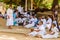 KANDY, SRI LANKA - JULY 19, 2016: White clothed buddhist pilgrims rest during Poya Full Moon holiday in Kandy, Sri Lan