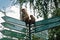 Kandy, Sri Lanka: Monkeys sitting on the tourist sign in Royal Botanical Gardens Peradeniya