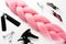 Kanekalon pink hair light pink on white background top view close clips a comb and the spray