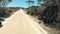 Kangaroo Island unpaved road along lake and trees, aerial view from drone - Australia