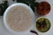Kanji and Kadumanga. Rice gruel prepared with Kerala Matta rice. Served with raw banana curry and Kerala style cut mango pickle