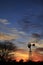 Kansas Awesome Sunset with colorful clouds, and a farm Windmill silhouette .