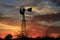 Kansas Awesome Sunset with colorful clouds, and a farm Windmill silhouette .