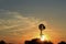 Kansas colorful Sunset with yellow and orange sky with a Windmill silhouette