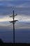 Kansas powerline silhouette at sunset with clouds west of Nickerson Kansas USA out in the country.