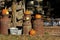Kansas Pumpkin`s on top of rusty Milk can`s on a farm with a fence out in the country.