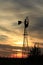 Kansas Windmill sunset with a tree silhouette with a colorful sky