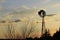 Kansas Windmill sunset with a tree silhouette with a colorful sky