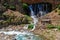 Kapuzbasi Waterfall in Aladaglar National Park Green trees round the waterfall soups composition.