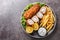 Karadjordjeva steak stuffed with kaymak, breaded and fried, served with french fries and tartar sauce close-up in a plate.