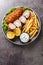 Karageorge Schnitzel Serbian Stuffed Cutlet served with french fries and tartar sauce close-up in a plate. Vertical top view