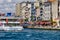 Karakoy Pier and the European part of the city, ferries with passengers floating to the pier, people walk along the