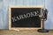 Karaoke written on vintage chalkboard with microphone