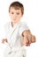 Karate boy in white kimono fighting isolated