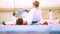 Karate children in white kimono and gloves lay on mats