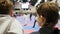 Karate competition - two teenagers boys looking at fighting on tatami