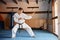 Karate Fighter practises fight in martial arts gym