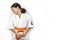 Karate girl on a white background. A sporty Caucasian laughing brunette in a white kimono is engaged in martial arts