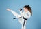Karate gives feeling of confidence. Strong and confident kid. She is dangerous. Girl little child in white kimono with