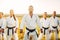 Karate group in white kimono, workout in field
