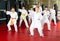 Karate kids in kimono performing kata moves