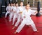 Karate kids in kimono performing kata moves