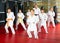 Karate kids in kimono performing kata moves