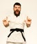 Karate man with angry face in uniform. Oriental sports concept. Jiu Jitsu master with black belt