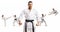 Karate master with black belt standing in front of men and women practicing martial arts