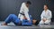 Karate student exercise, learning and training with mma coach teaching, sports and workout at gym. Wellness, sport and