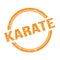 KARATE text written on orange grungy round stamp