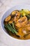 Kare kare; a mix of ox tail and tripe with vegetables like eggplant, sitaw long bean, pechay, puso ng saging stewed in peanut sa