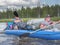 Karelia, Vodlozero - 29.07.2019: Tourists, father and son in boat. Ecotourism, visiting fragile, undisturbed natural areas. Active