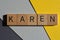 Karen, word in 3d wooden alphabet letters isolated on yellow and grey