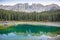 Karersee or Lago di Carezza, is a lake with mountain range of the Latemar group on background in the Dolomites in Tyrol