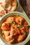 Karhai chicken in a spicy tomato sauce closeup served with naan. Vertical top view