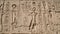 Karnak temple heiroglyphic pharaoh and god carving on stone wall