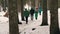 KARPATY, HOVERLA, UKRAINE - MARCH 2023: A group of tourists with backpacks and raincoats climb a mountain in the middle