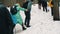 Karpaty, Hoverla, Ukraine - March 2023: A group of tourists with backpacks and raincoats climb a mountain in the middle