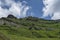 Karst landforms in green steep mountain slope