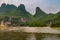 Karst mountain grouip with brown water in front along Li River in Guilin, China