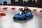 Karting area with barriers and small blue kart